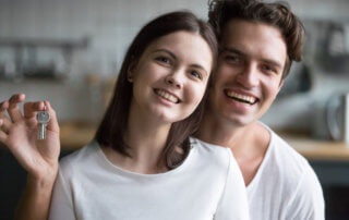 young couple holding key