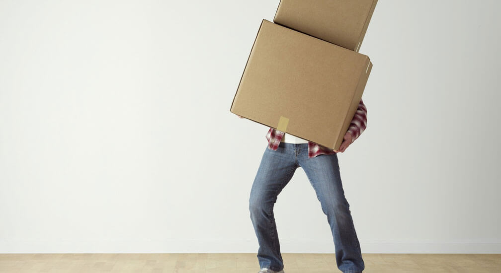 man carrying boxe